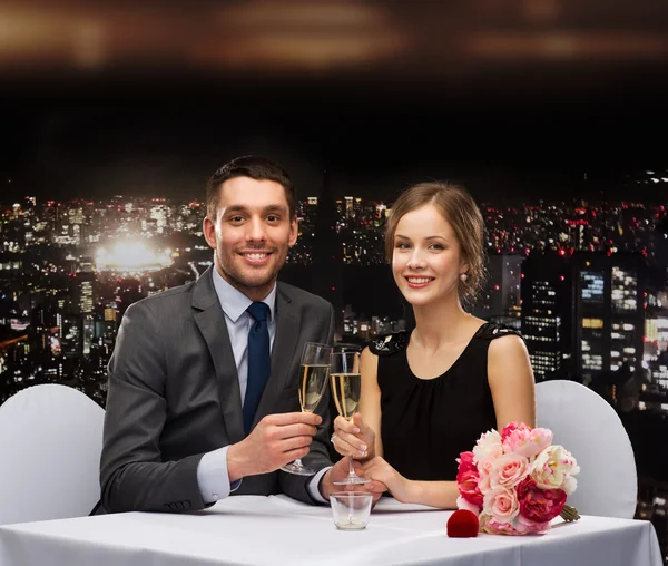 Couple with glasses of champagne at restaurant — Stock Photo, Image