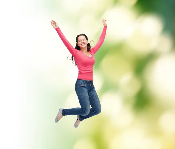Gülümseyen genç kadın havada zıplıyor. — Stok fotoğraf