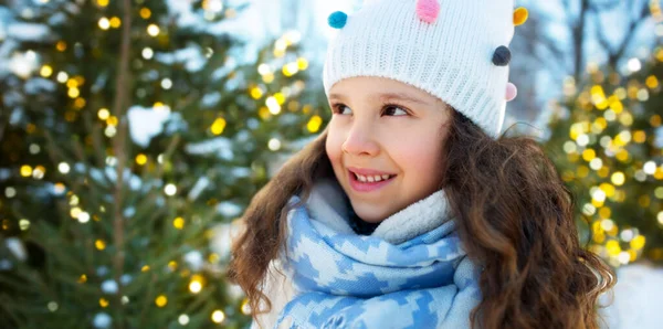 Portrait of happy little girl over christmas trees — Stock Photo, Image