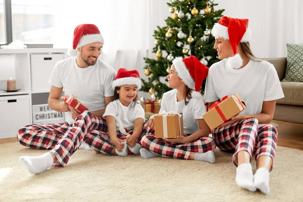 Happy family with christmas gifts at home — Stock Photo, Image
