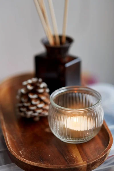 Candle holder, reed diffuser and pine cone at home — Stock Photo, Image