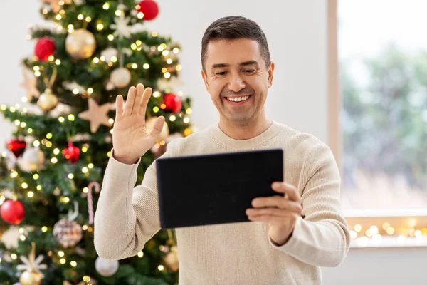 Man with tablet pc having video call on christmas — Stock Photo, Image
