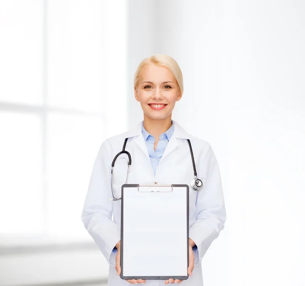 Smiling female doctor with clipboard — Stock Photo, Image