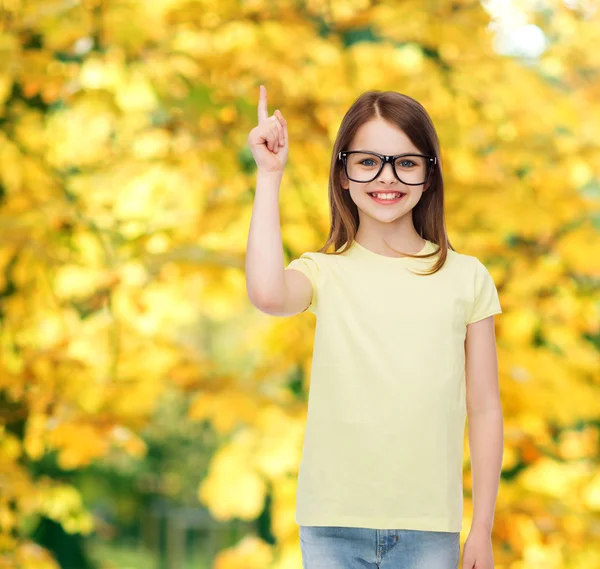 Smiling cute little girl in black eyeglasses — Stock Photo, Image