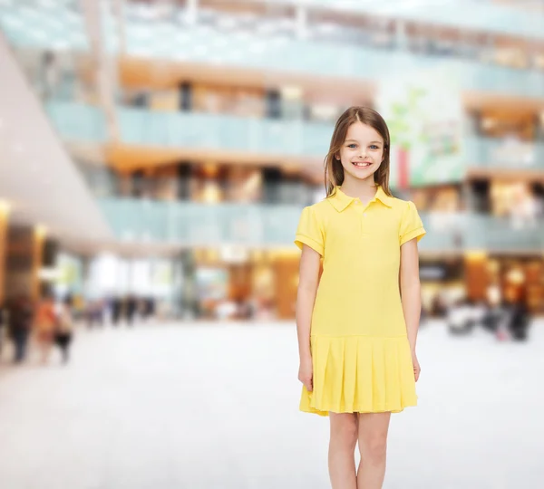 Smiling little girl in yellow dress — Stock Photo, Image