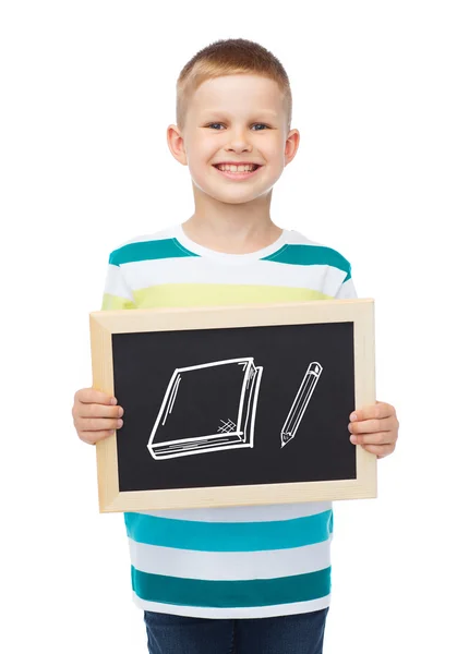 Smiling little boy with blank blackboard — Stock Photo, Image