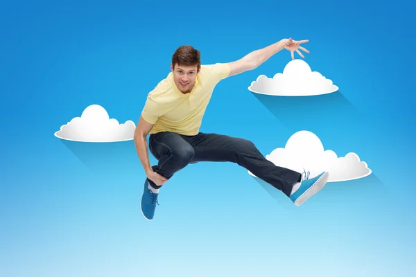 Smiling young man jumping in air — Stock Photo, Image