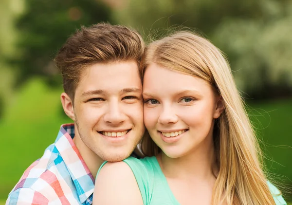 Smiling couple hugging in park — Stock Photo, Image