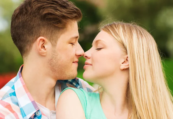 Smiling couple touching noses in park Stock Picture