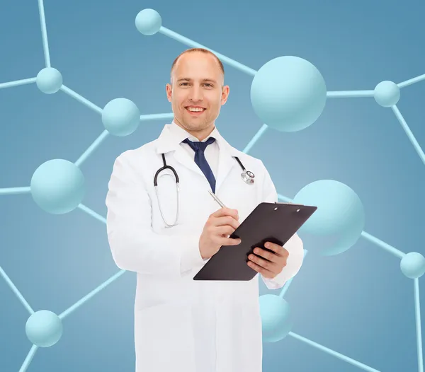 Smiling male doctor with clipboard and stethoscope — Stock Photo, Image