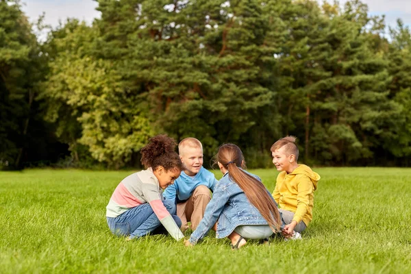Happy children playing round dance at park Royalty Free Stock Photos