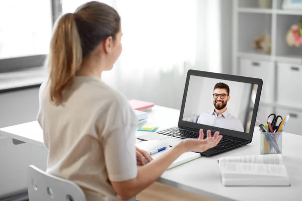 Stock image student woman with laptop has video call with man