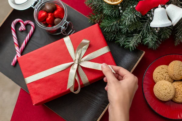 Рука с рождественским подарком, угощениями и украшениями — стоковое фото