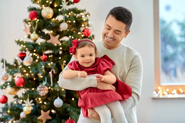 Счастливый отец и маленькая девочка на новогодней елке — стоковое фото