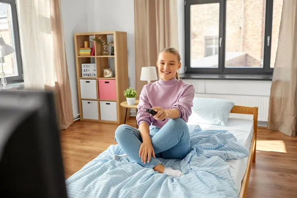 Menina sorridente feliz assistindo tv em casa — Fotografia de Stock