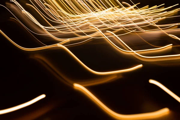 Golden electric light effect on dark background — Stock Photo, Image