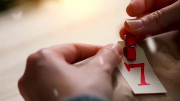 Hands making advent calendar on christmas at home — Stock Footage Hands making advent calendar on christmas at home Stock Footage