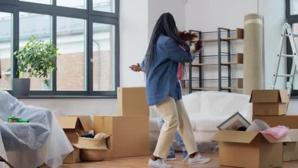 Mujeres con cajas moviéndose en casa nueva y bailando — Vídeo de stock