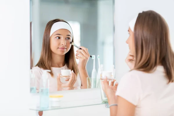 Teenager-Mädchen trägt Gesichtsmaske im Badezimmer auf — Stockfoto