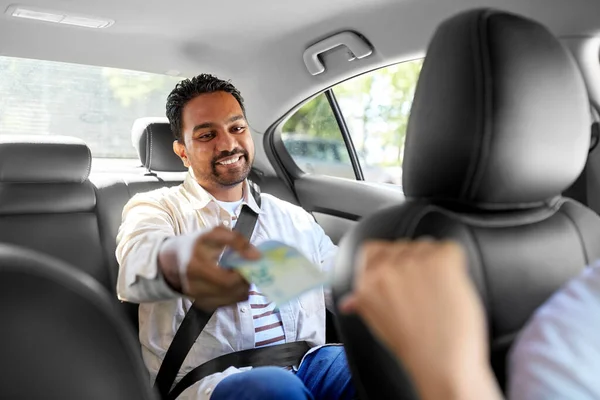 Gelukkig man geven geld aan taxi automobilist — Stockfoto