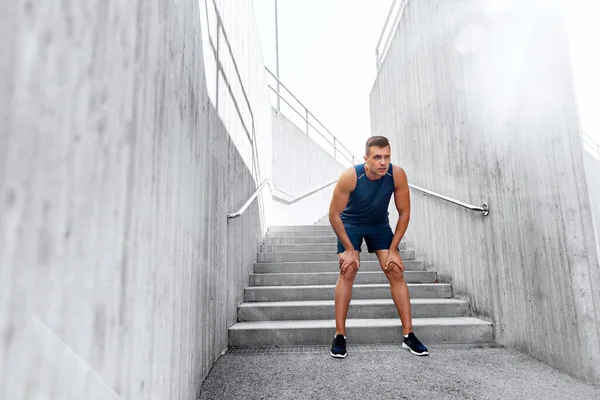 Tired young man doing sports outdoors — Stock Photo, Image