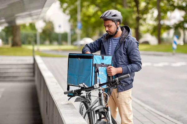 Hombre con bolsa de comida y bicicleta en la ciudad —  Fotos de Stock