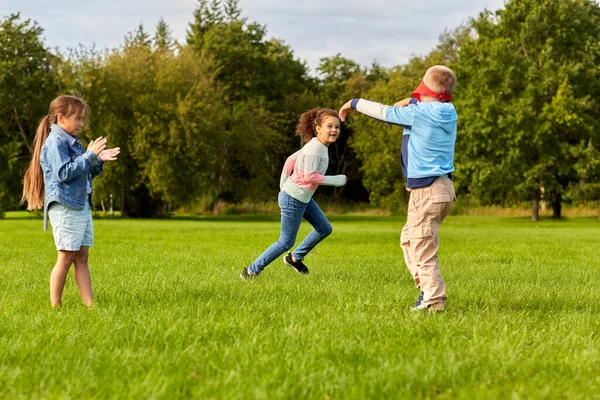 Niños felices jugando y corriendo en el parque — Foto de Stock
