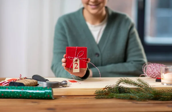 自宅でクリスマスプレゼントを見せる女性のクローズアップは — ストック写真