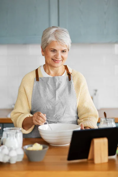 Frau mit Tablet-Computer kocht Essen in Küche — Stockfoto