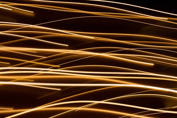 Efeito de luz elétrica dourada no fundo escuro — Fotografia de Stock