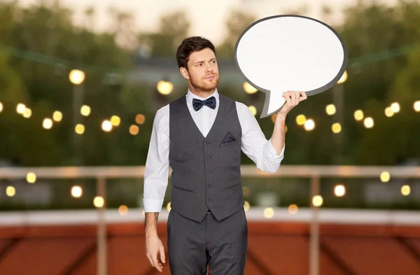 Man in suit with text bubble at rooftop party — Stock Photo, Image