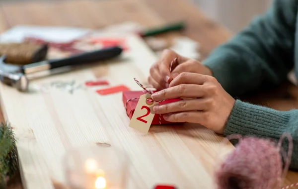Mãos de embalagem presente de Natal para o segundo dia de advento — Fotografia de Stock