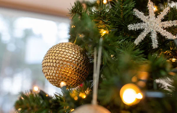 Close up of golden ball on christmas tree — Stock Photo, Image