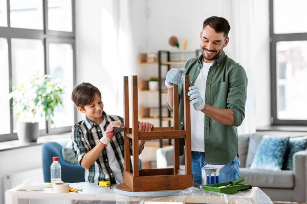 Father and son sanding old table with sponge — Stock Photo, Image