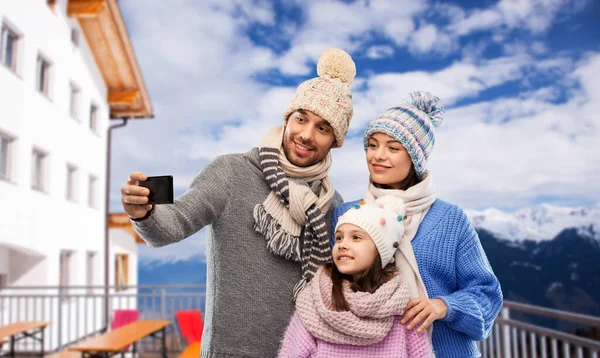 Happy family taking selfie by smartphone in winter — Stock Photo, Image