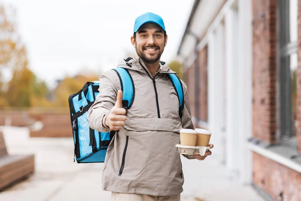 Happy delivery man with thermal bag and coffee — Stock Photo, Image