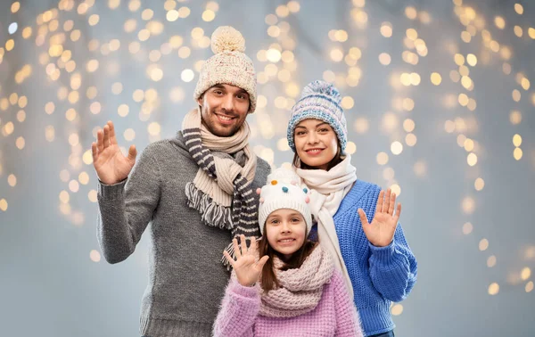 Ευτυχισμένη οικογένεια σε χειμωνιάτικα ρούχα που κουνώντας τα χέρια — Φωτογραφία Αρχείου
