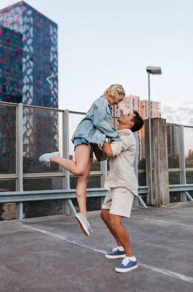 Felice giovane coppia sul tetto parcheggio della città — Foto Stock