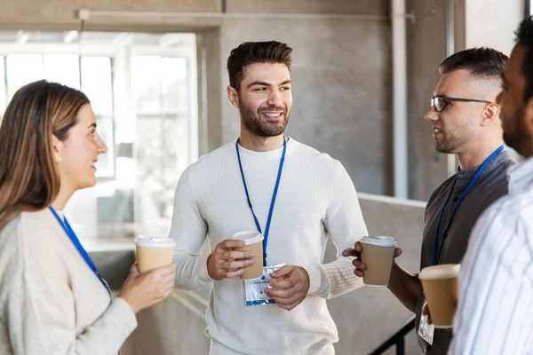 Zakenmensen die afhaalkoffie drinken op kantoor — Stockfoto