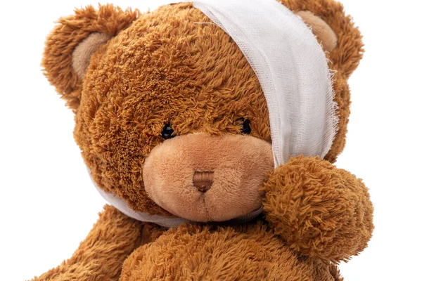 Teddy bear toy with bandaged head having toothache — Stock Photo, Image