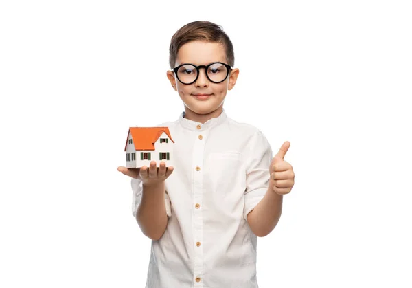 Little boy in glasses with toy house model — Stock Photo, Image