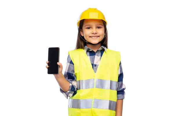 Menina no capacete de construção com smartphone — Fotografia de Stock
