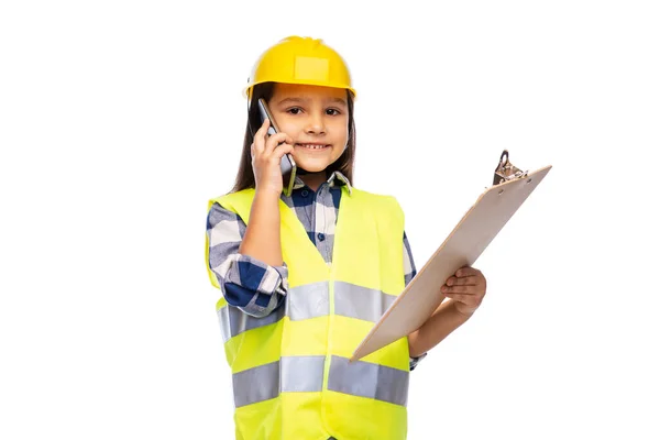 Girl in helmet with clipboard calling on phone — Stock Photo, Image