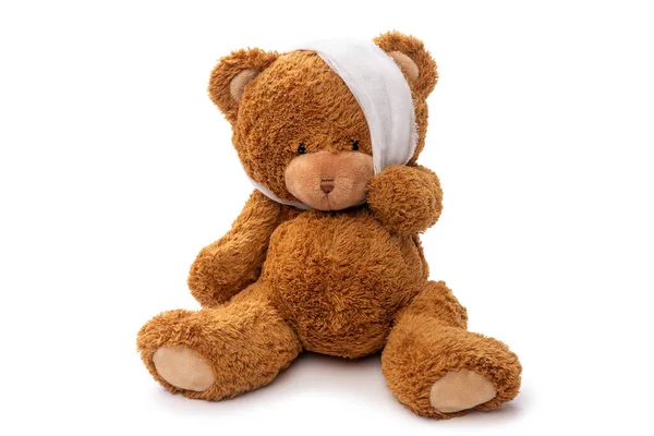 Teddy bear toy with bandaged head having toothache — Stock Photo, Image