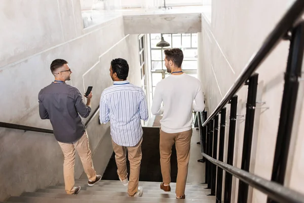 Hommes marchant dans les escaliers du bureau et parlant — Photo