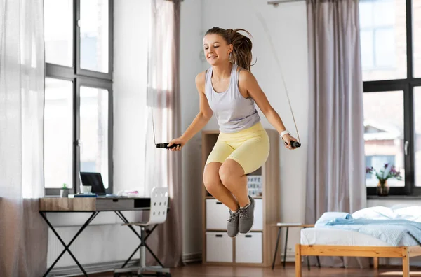 Nastolatka dziewczyna ćwiczenia z skakanką w domu — Zdjęcie stockowe