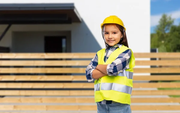 Smiling little girl in helmet and safety vest — Stock Photo, Image