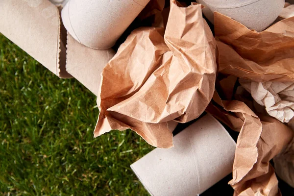 Close up of crumpled paper waste on grass — Stock Photo, Image