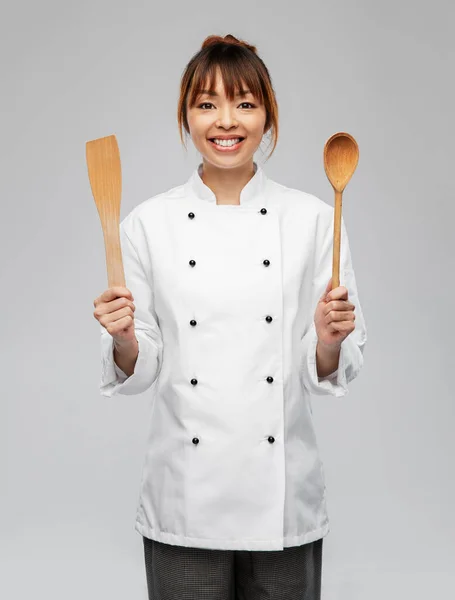 Happy smiling female chef with wooden spoon — Stock Photo, Image