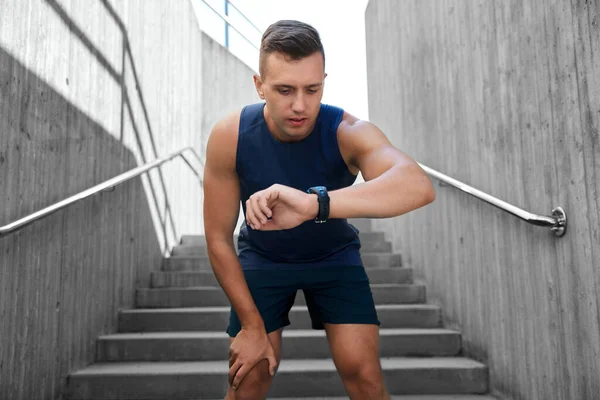 Young man with fitness tracker outdoors — Stock Photo, Image